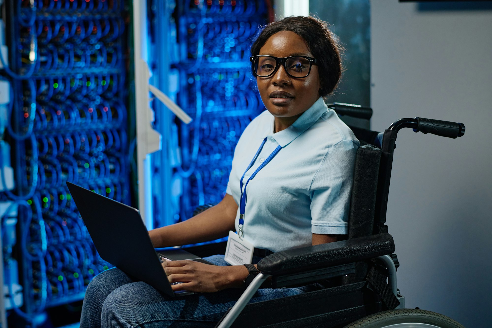 Female IT engineer with disability working on laptop