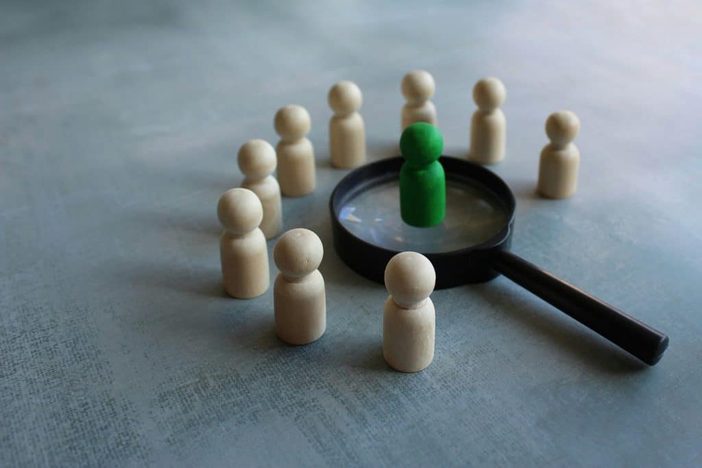 Wooden dolls and magnifying glass